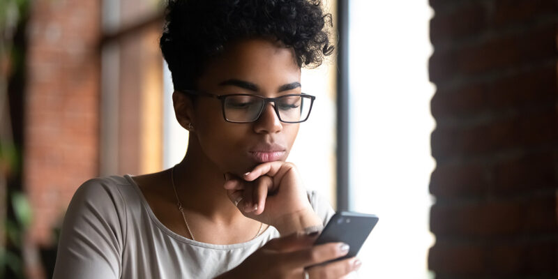 Woman With Glasses Searching on Smartphone